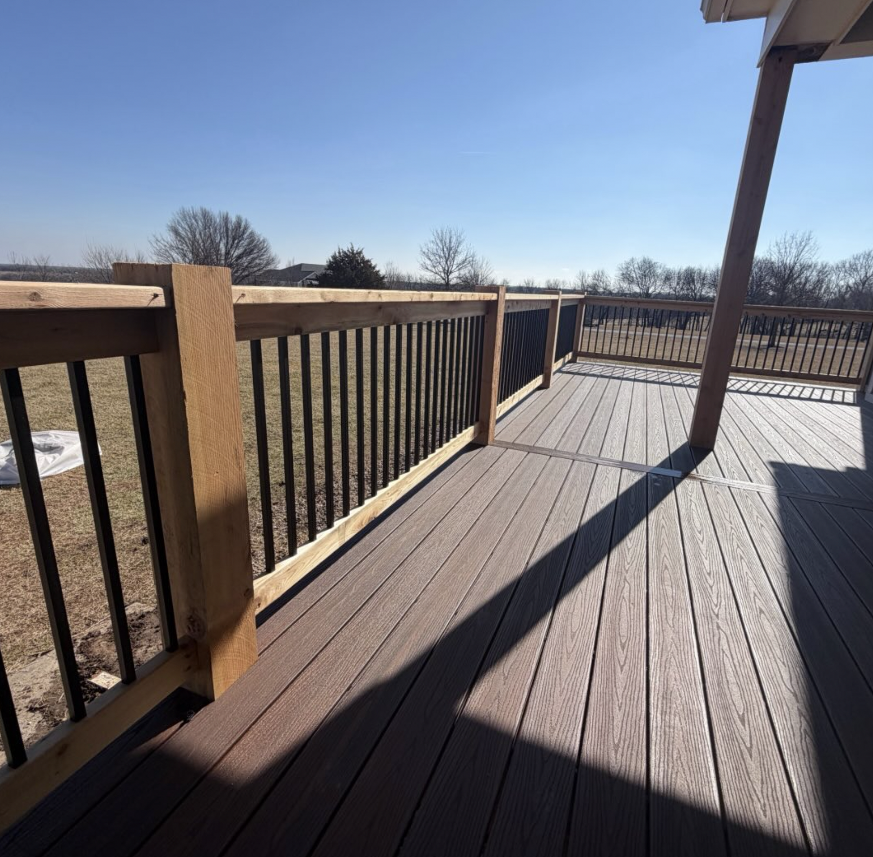 Finished Kansas City covered deck with composite railing detail